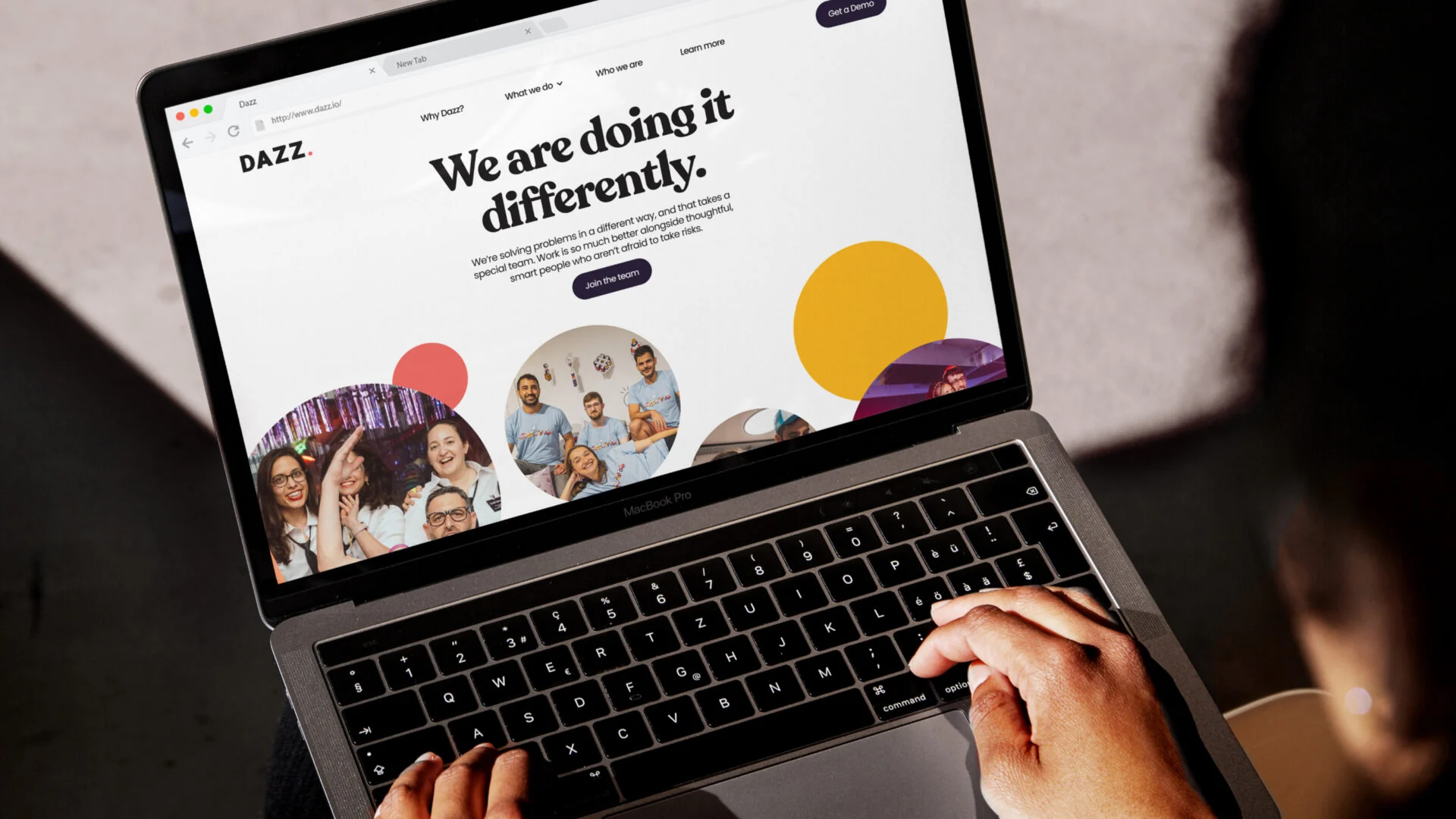 The Dazz website on a laptop — a bright, human brand with a serif 'We are doing it differently' headline, playful circles, and team photos.